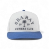 Front view of a white Sea Ray hat with a blue bill and embroidered “Sea Ray Owners Club 1959” logo with palm tree graphic.