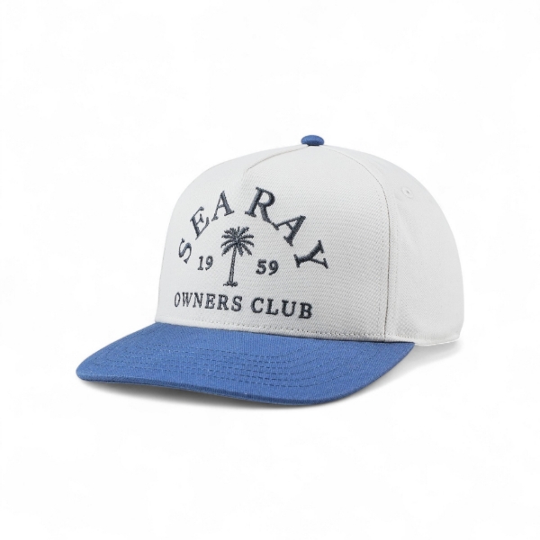 White Sea Ray hat shown at a three‑quarter left angle with a blue bill and embroidered “Sea Ray Owners Club 1959” logo on the front.